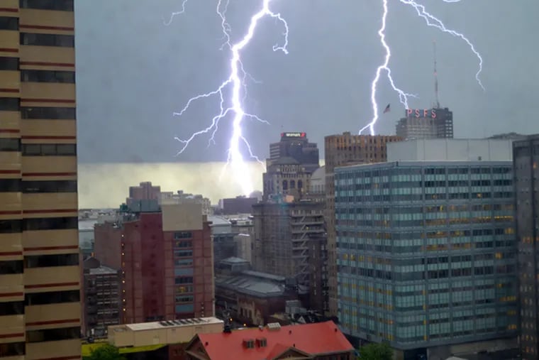 A lightning bolt streaks down in Center City during powerful storms Thursday, July 3, 2014. (Photo by Sophia Cassidy, 12, of Poughkeepsie, N.Y., who aptly described it as an "insane lightning bolt.")
