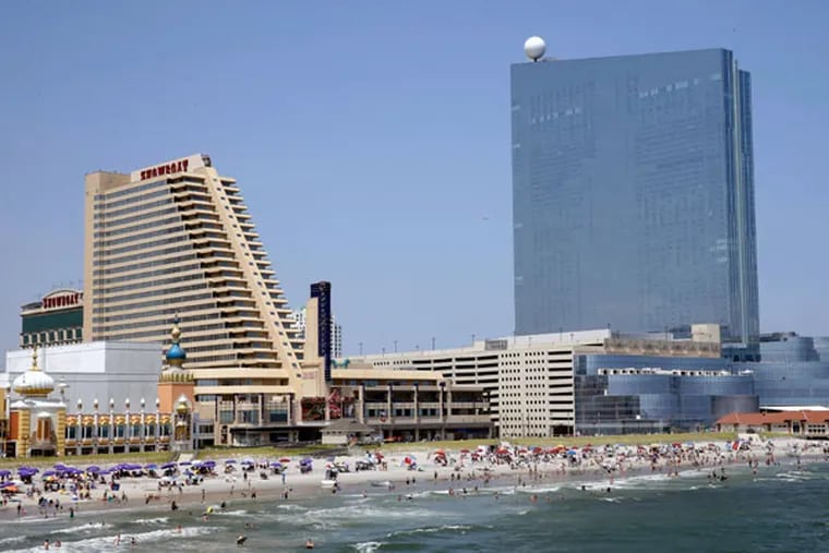 The Showboat (left) and the Revel. New Revel owner Glenn Straub would buy the Showboat from the college. (AP File)