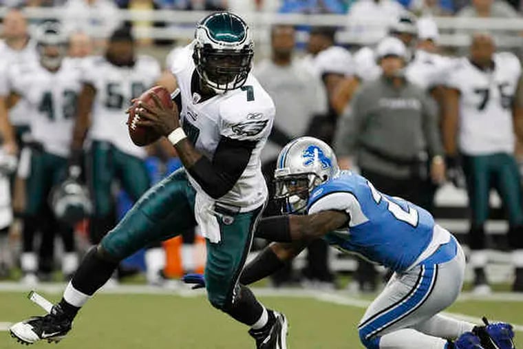 With legs as lively his arm, Michael Vick escapes the Lions' Alphonso Smith before hitting wide receiver Riley Cooper for 20 yards in the second quarter.