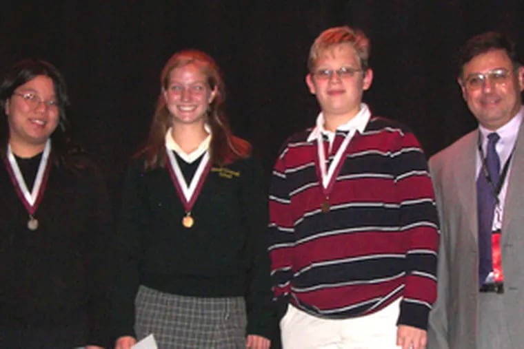 Excelling at the math competition were (from left): Brittany Wun, Emily Hansinger and Christopher Hobson. At right is Frank Sgroi, Holy Cross mathematics department chair, who oversaw the event.