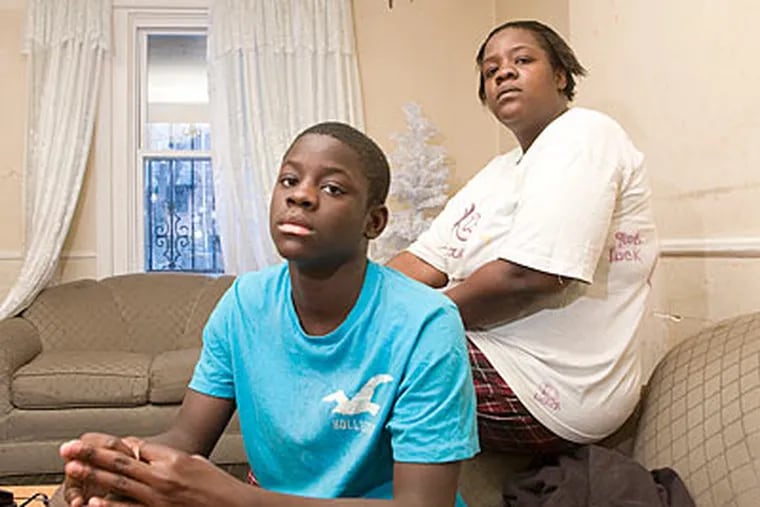Walter Ransome with his mother, Veronica Goss, at home in Philadelphia. They believe the school district was unfair to suspend only Walter for having sex with a girl at school. (Jessica Griffin / Staff Photographer)