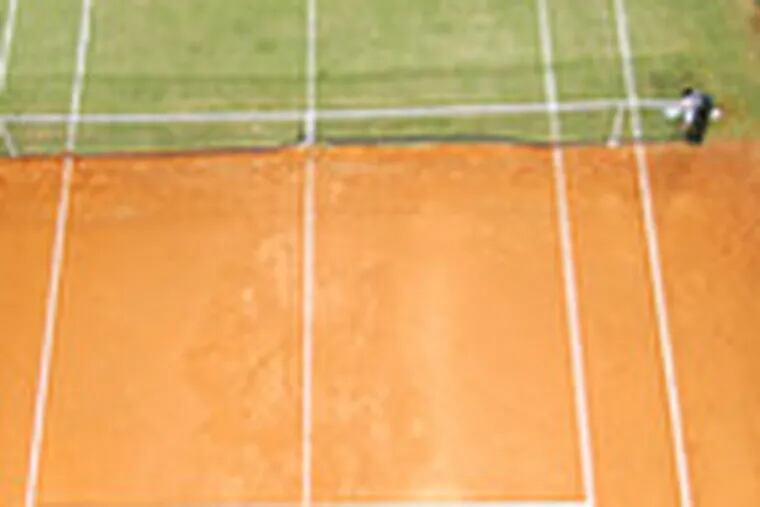 Clay-court specialist Rafael Nadal (bottom) returns the ball to grass specialist Roger Federer in an exhibition on a half-grass, half-clay court in Spain. C7.