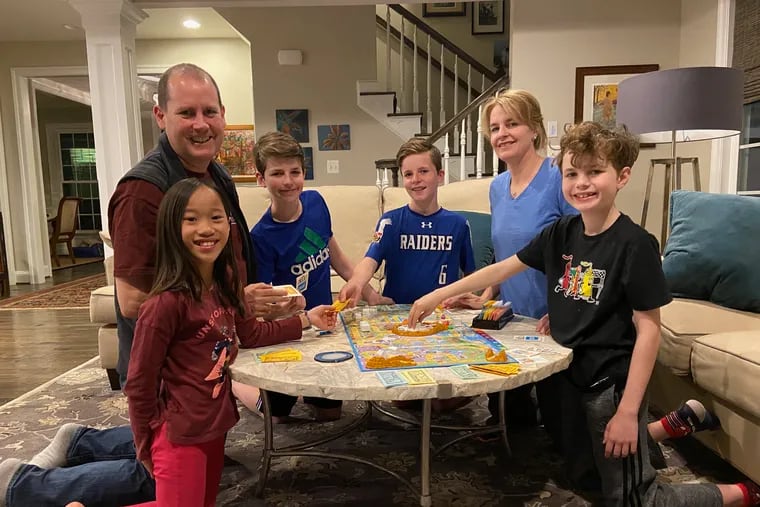 Erin O’Connor and her family play a board game on a recent evening. From left, Shea, 9, Brennan O’Brien, 47, Rory, 13, Eamon, 11, Erin O’Connor, 46, and Hugh, 9.