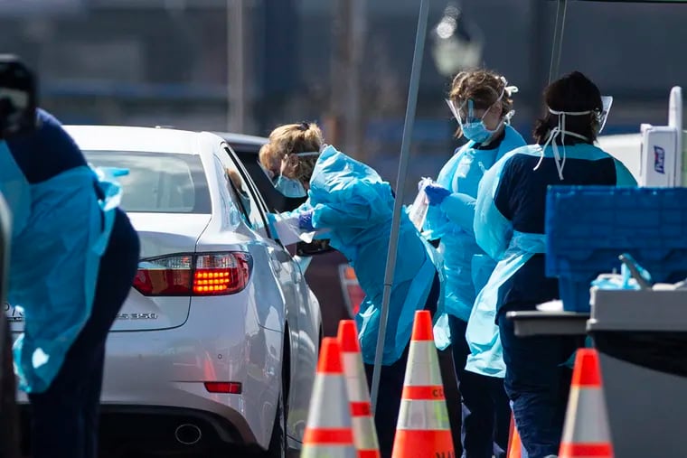Registered nurses helped with ChristianaCare's drive-through collection of swabs from people with coronavirus symptoms on March 13. The collection site was in a parking lot along Beech Street in Wilmington.