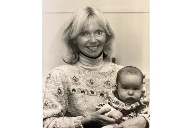 Bonnie Packer in the early 1990s, holding a baby in her office at the Philadelphia College of Pharmacy and Science, now the University of the Sciences in Philadelphia. Packer worked in the office of student health for more than 30 years and laments that the new merger with St. Joseph's University means it can no longer dispense birth control.