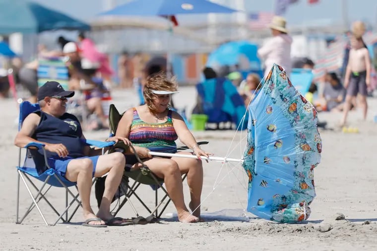 A couple at the Wildwood beach in July, the day that NOAA said it knew something was wrong with Jersey's only near-shore ocean-temperature gauge.