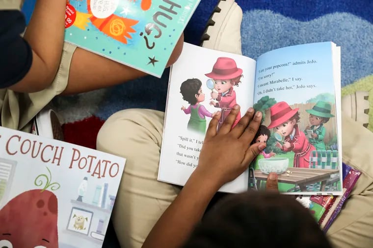 First graders look through their new books at Mastery Harrity Elementary School in Philadelphia, Pa. during a free book fair hosted by Scholastic and "Abbott Elementary."