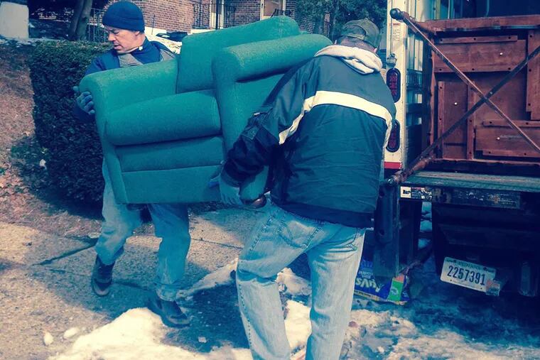 Workers with Pathways to Housing PA’s furniture bank deliver donated furniture to families in need. The bank opened in December and has already helped about 20 families and 13 member agencies furnish their spaces. (HELEN UBINAS / DAILY NEWS STAFF)