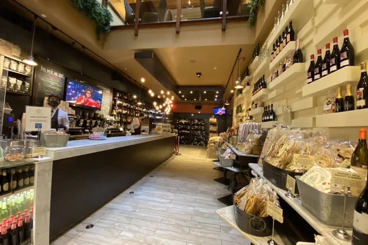 Tables at Gran Caffe L'Aquila have been removed in favor of shelves of groceries.