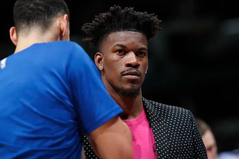 Philadelphia 76ers guard Jimmy Butler, back, confers with guard Ben Simmons during a timeout in the second half of the team's NBA basketball game against the Denver Nuggets on Saturday in Denver.(AP Photo/David Zalubowski)