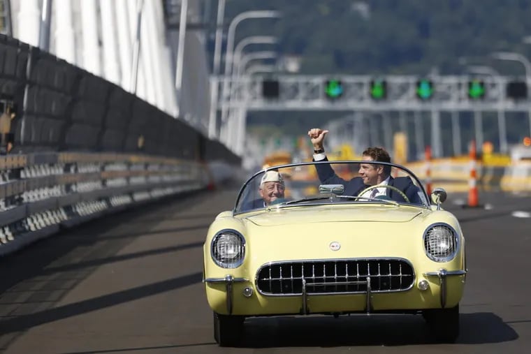 New York Gov. Andrew Cuomo (right) and Armando  Galella cross a span of the bridge named for Cuomo’s father in a 1955 Corvette.