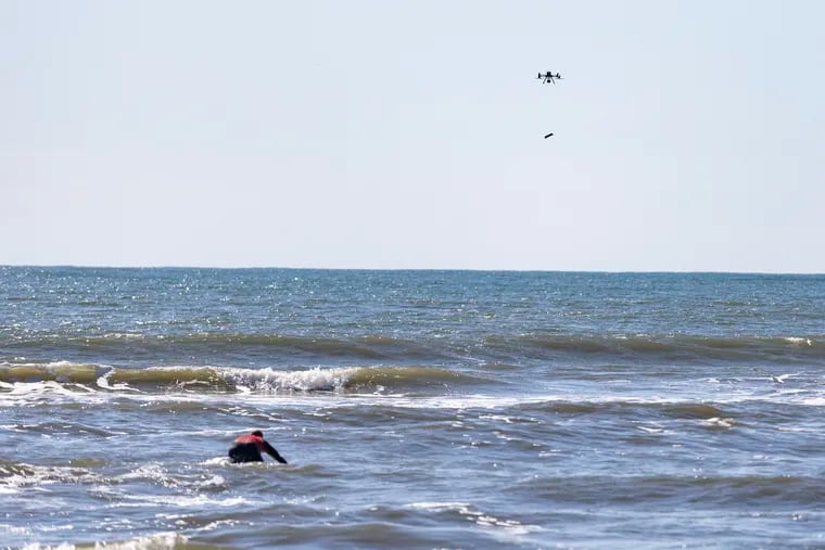 A drone drops an inflatable rescue tube into the water to Brendan Santangelo, a lead guard with the Atlantic City Beach Patrol, as he acts as a rescue victim in the ocean during a demonstration in Atlantic City on Tuesday.