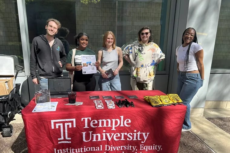 Temple students working on the "Mapping Spaces of Meaning" project set up a table on campus to talk to other students about their religious practices. From left to right are Micah Katz Zeiger, Sidney Raine Jeffries, Graysen Gill , Asher Simone Chelder, and Sya Smith.