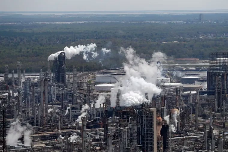 In this March 8, 2018, file photo wetlands are seen beyond the Shell Norco refinery in Norco, La. The world may be heading into an oversupply of oil, and that possibility is hanging over members of the OPEC cartel, which will meet later this week to decide whether to further cut production to boost prices.