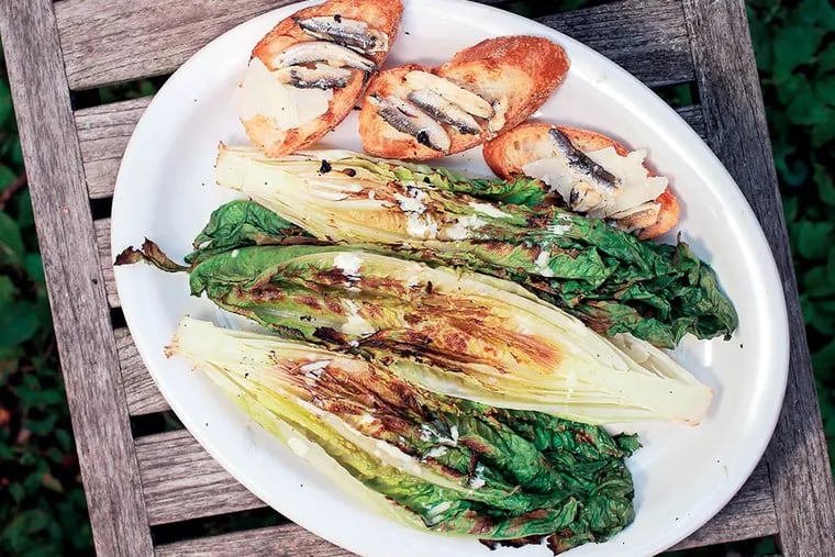 Grilled romaine salad, with romaine lettuce, anchovies, and bread, that will be cut for croutons. Anna Herman writes about some of the more unusual items she likes to cook on her grill: romaine for a grilled salad, quesadillas, and grilled pound cake for dessert. with three recipes. Grilled romaine salad, quesadilla and grilled pound cake with fruit.  ( MICHAEL BRYANT  / Staff Photographer )
