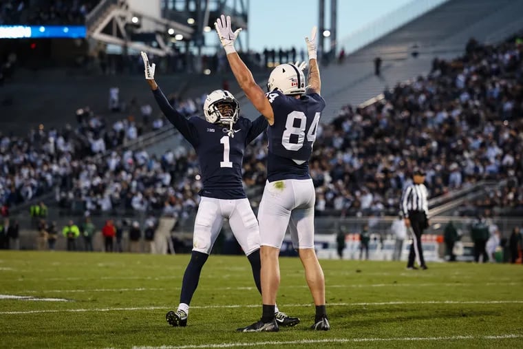 Theo Johnson #84 of the Penn State Nittany Lions celebrates with KeAndre Lambert-Smith #1 after catching a pass for a touchdown against the Michigan State Spartans during the first half at Beaver Stadium.