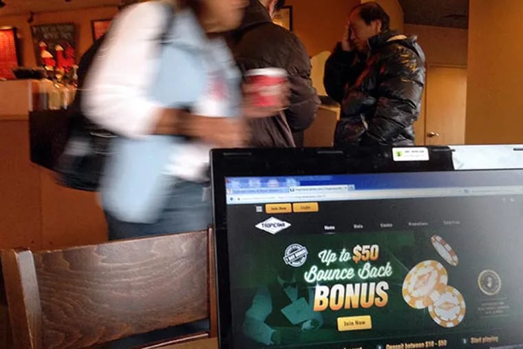 Inquirer Staff Writer Jacqueline L. Urgo logs on to the Tropicana website to gamble online in New Jersey, November 26, 2013, at a Starbucks in Galloway Township. ( TOM GRALISH / Staff Photographer )