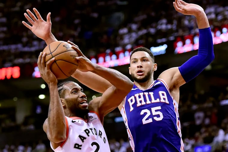 Kawhi Leonard (2) looks for the shot as Philadelphia 76ers guard Ben Simmons (25) defends during the second half of Game 1 of a second-round NBA basketball playoff series, in Toronto, Saturday, April 27, 2019.