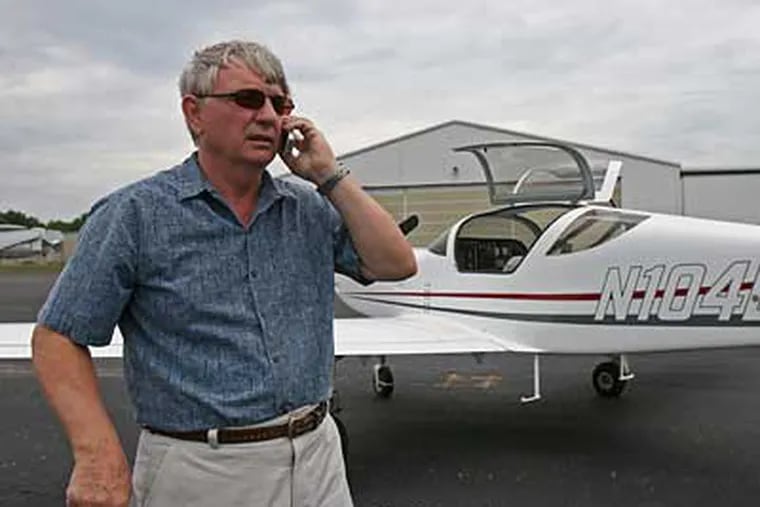 Dick Pettigrew of Moorestown, N.J., speaks with airport personnel before taking off in his Glasair III Experimental plane at the South Jersey Regional Airport. (Neal Santos / Inquirer)