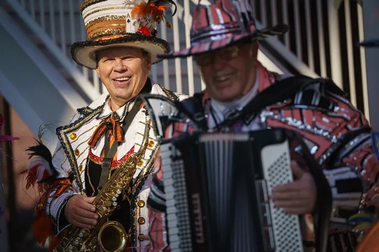 Gary Stachowicz, left, from the South Philly String Band, and Steve Morris, right, from the Aqua String Band, perform at a press conference at Arthaus Condominiums by Dranoff Properties, during which it was announced that the Mummers Parade is returning to Broad Street on New Year's Day.