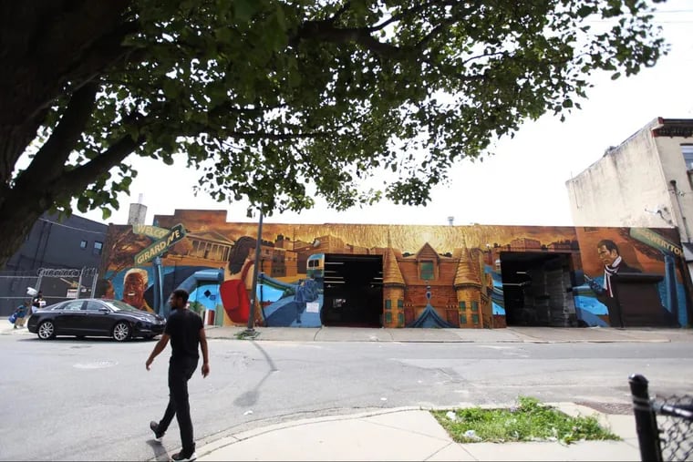 A mural decorates a building on the block in Brewerytown where a fight between members of Steelworks Strength Systems gym and nearby residents broke out last month.
