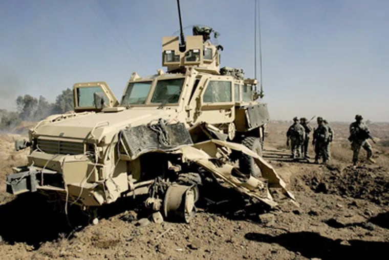 A U.S. MRAP — Mine Resistant Ambush Protected vehicle — damaged by a roadside bomb in Iraq. Better armor is needed to protect against such blasts. (Petros Giannakouris / Associated Press, file)