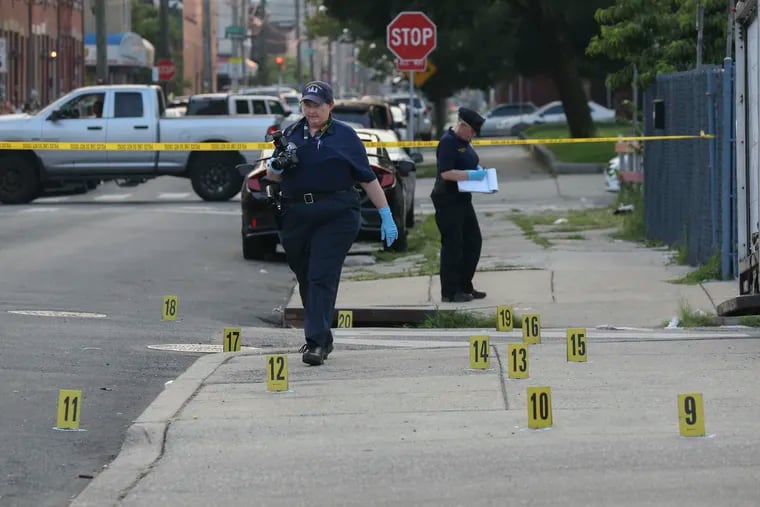 Crime scene officers on the scene where a woman, 25, was fatally shot on the 300 block of West Huntingdon Street shortly before 6 p.m. Over 25 shell casings were found at the scene,  Monday, July 19, 2021