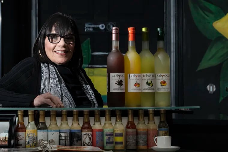 Joanie Verratti, owner of Pollyodd liquor store in South Philly, with a few of her products.