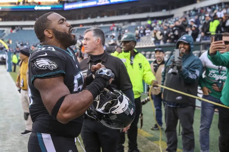 Brandon Graham (left) yells to the crowd around the tunnel after the Eagles beat Chicago, 22-14, on Nov. 3, 2019.