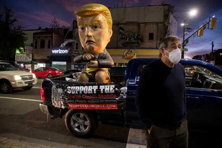 Don Lessem, of Media, talks with people near his Trump Death Mobile at Broad and Erie Streets on Election Day in Philadelphia, Pa. on Tuesday, November 3, 2020.  Lessem spent most the day driving the death mobile around Delaware County.
