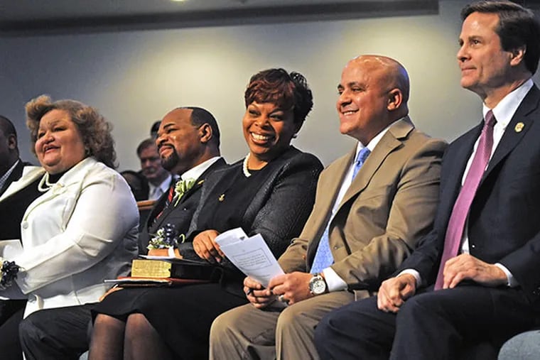 Dana Redd is inaugurated as Mayor of Camden, NJ at Antioch Baptist Church on Jan. 7, 2014. Here, from left to right, City Council members-elect Arthur Barclay (partially obscured), Marilyn Torres and Curtis Jenkins, Dana Redd, Council President Frank Moran, and State Senator Donald Norcross. ( APRIL SAUL  / Staff )