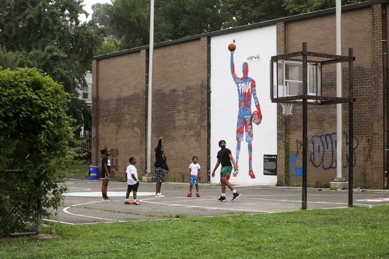 Kids play on the court at the Daniel E. Rumph II Recreation Center in the Germantown section of Philadelphia, Pa., on Tuesday, July 13, 2021.