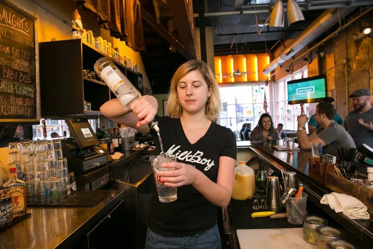 Bartender Rebecca Schmitt makes a Manmosa (Stoli orange vodka, champagne, and orange juice) while working the early-morning shift at MilkBoy.