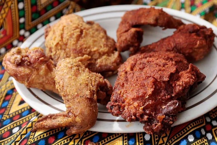 The gluten-free fried chicken, a milder “Alicha” (left) and the spicy red “Awaze” at Doro Bet, 4533 Baltimore Ave. in Philadelphia.