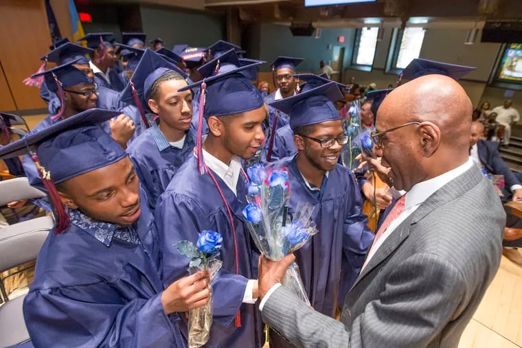 Founder and CEO David Hardy is presented roses by members of the graduating class during the Boys Latin graduation ceremony on June 13, 2017. Hardy dreamed of opening a charter school for male students in Philadelphia modeled after the famed Boston Latin School. Ten years after Boys Latin of Philadelphia opened, at least 84 percent of Boys Latin's grads go to college and earn degrees.