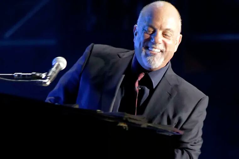Billy Joel sits at the piano for the 2nd song "Pressure" which he sang to a sold out crowd at Citizens Bank Park in Phila. on Aug. 2, 2014.