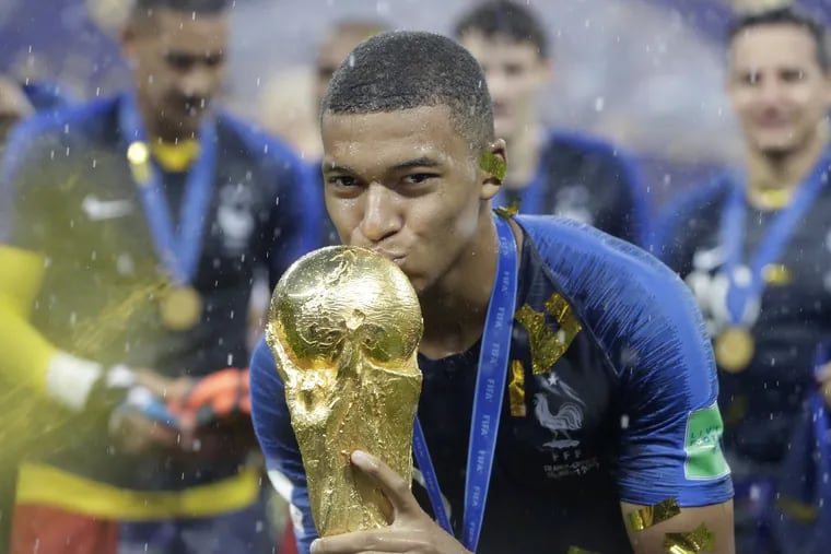 Kylian Mbappe kisses the trophy after helping France dump Croatia to win the World Cup finale in Moscow.