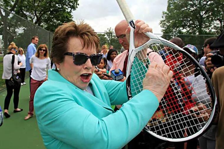 Tennis great Billie Jean King plays some air guitar on a tennis racket as the Rocky theme plays over the sound system. A year ago, King helped dedicate the $550,000 refurbishing of the Hunting Park Tennis Courts. ( CHARLES FOX / Staff Photographer )