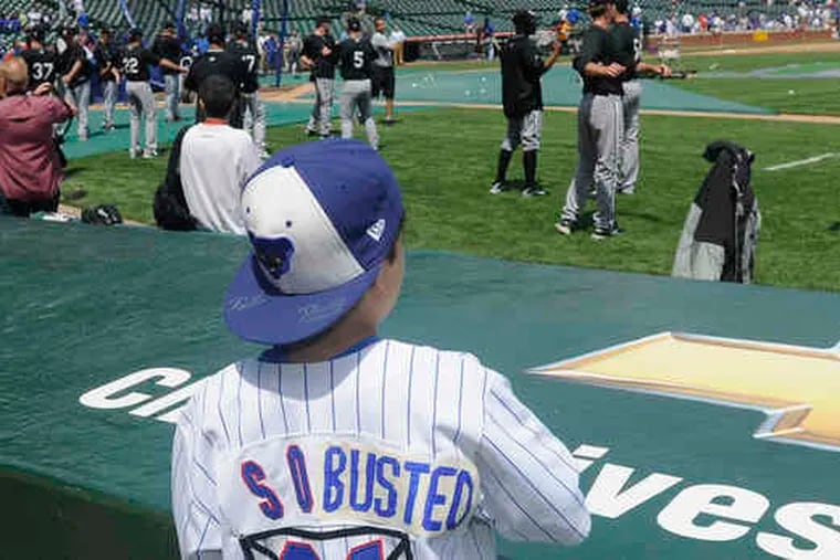 Baseball fan Sam Harris, 12, of Buffalo Grove, Ill., wears an altered Sammy Sosa jersey to yesterday's Cubs-White Sox game.