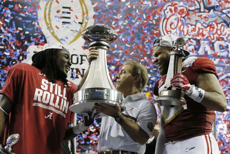 Alabama head coach Nick Saban with running back Bo Scarbrough (left) and linebacker Ryan Anderson celebrate after defeating Washington in Peach Bowl.