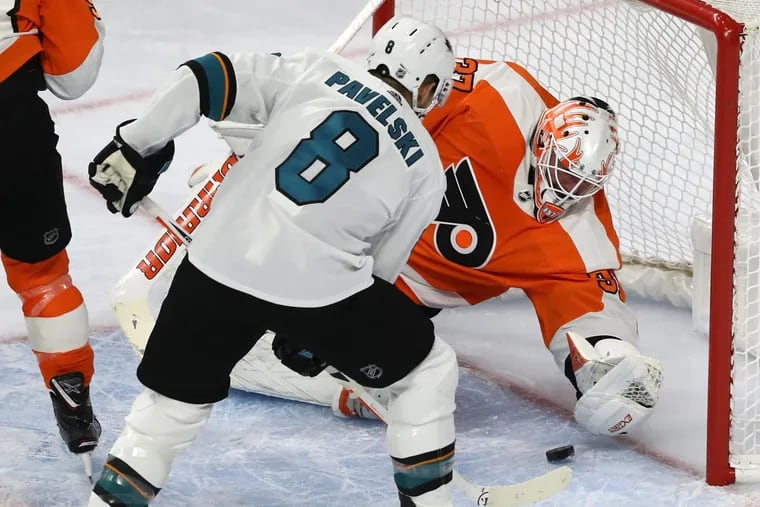 San Jose's Joe Pavelski scores one of his two first-period goals Tuesday against his former University of Wisconsin teammate, Brian Elliott, of the Flyers.