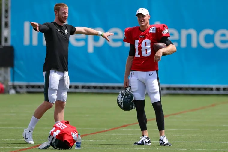 Eagles quarterbacks Carson Wentz, left, and Josh McCown speak during warmups before a joint practice with the Ravens at the NovaCare Complex on Tuesday
