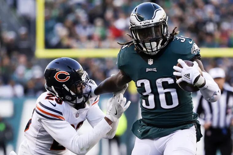 Eagles running back Jay Ajayi runs with the football past Chicago Bears cornerback Kyle Fuller in the fourth quarter on Sunday.