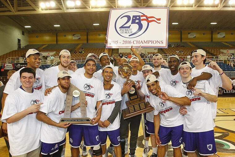 Holy Cross players pose with the championship trophy after defeating Lehigh 59-56 in the NCAA college basketball Patriot League Championship game at Lehigh in Bethlehem, Pa., Wednesday, March 9,
2016.