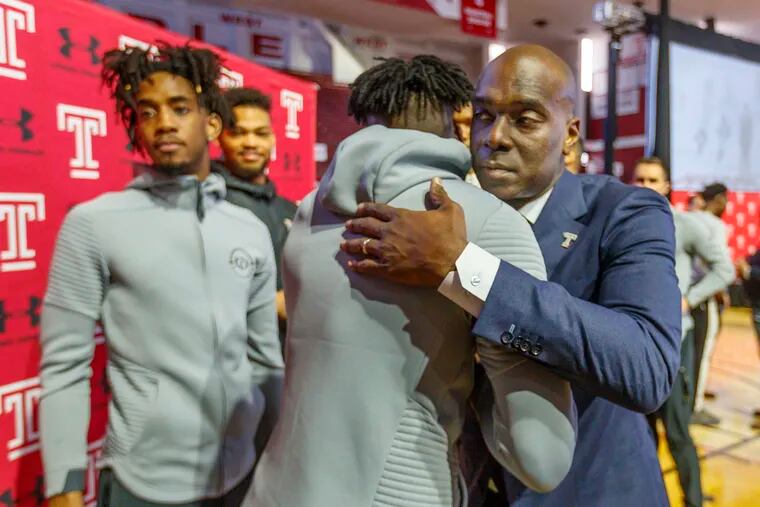 Aaron McKie, Temple's new men's basketball coach, right, gives Damion Moore, one of Temples players a hug after McKie was officially introduced the new coach on April 2, 2019.
