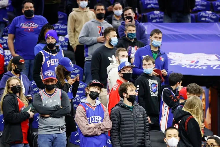 Masked Sixers fans watch pregame warm-ups before the Sixers play the Toronto Raptors in game two of the Eastern Conference quarterfinals playoffs after Philadelphia reinstated an indoor mask mandate on Monday.