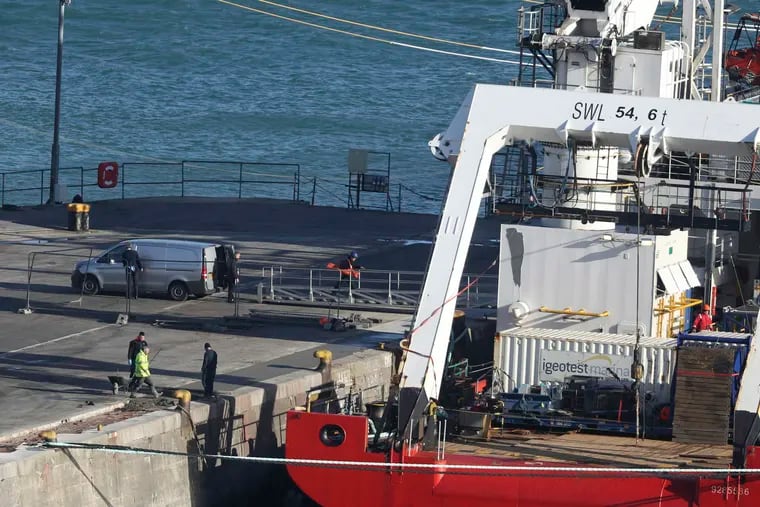 A van stands by the Geo Ocean III specialist search vessel docked in Portland, England, which is carrying a body recovered from the wreckage of the plane carrying Cardiff City footballer Emiliano Sala and pilot David Ibbotson, Thursday Feb. 7, 2019. (Steve Parsons / PA via AP)