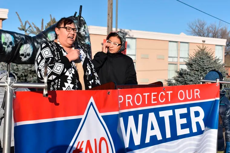 Angeline Cheek, left, a community organizer from the Fort Peck Indian Reservation, speaks about the potential environmental damage from the Keystone XL oil pipeline from Canada during a demonstration in Billings, Mont. on Tuesday, Oct. 29, 2019. (AP Photo/Matthew Brown)
