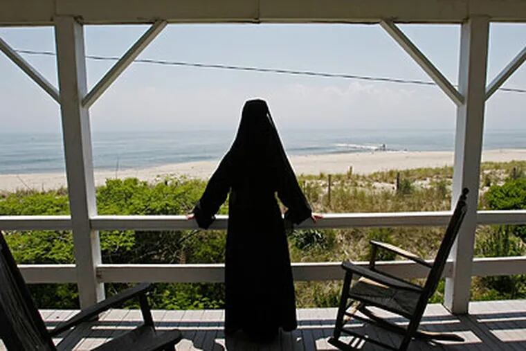 Sister Peg Conboy of the Sisters of Saint Joseph models the type of habit worn in 1909 and views the ocean from a second story porch. (Michael S. Wirtz / Staff Photographer)