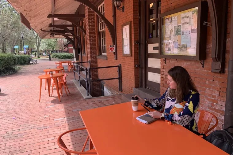 Jennilyn Schuster, main street manager for Downtown Bellefonte Inc. sits at the borough's outdoor working space in Talleyrand Park.